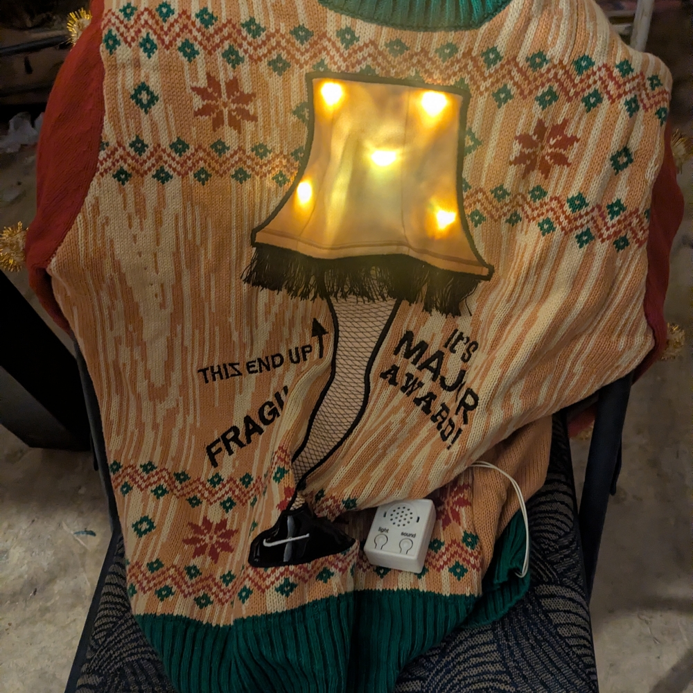 Spencer's Holiday Blanket with Light-Up Leg Lamp Design